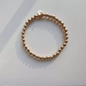 Złota bransoletka elastyczna z dużych kulek